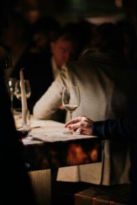 Sophisticated wine tasting in a cozy, dimly lit bar setting featuring elegant glassware and a relaxed ambiance.